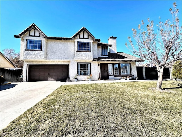 view of front of home with a garage and a front lawn