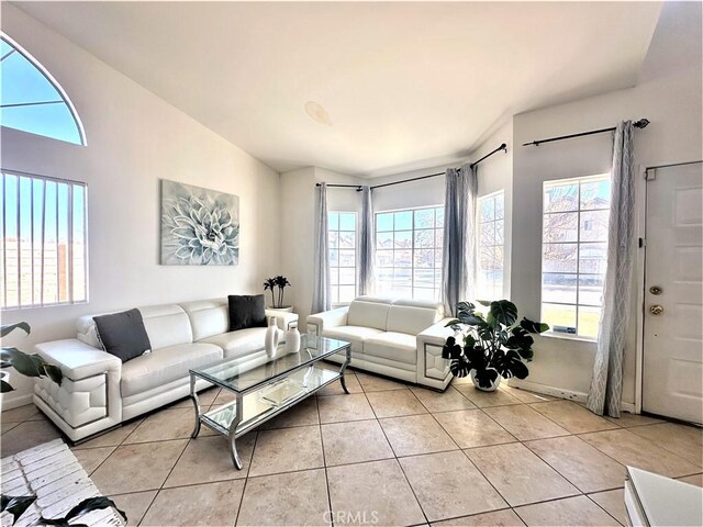 tiled living room featuring lofted ceiling