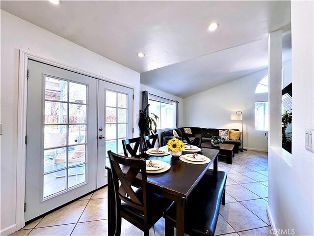 dining space featuring vaulted ceiling, french doors, and light tile patterned floors