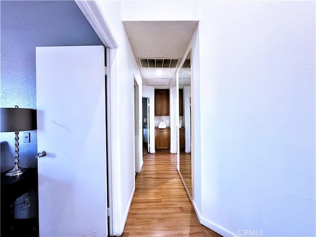 corridor with light wood-type flooring