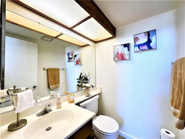 bathroom featuring toilet and vanity