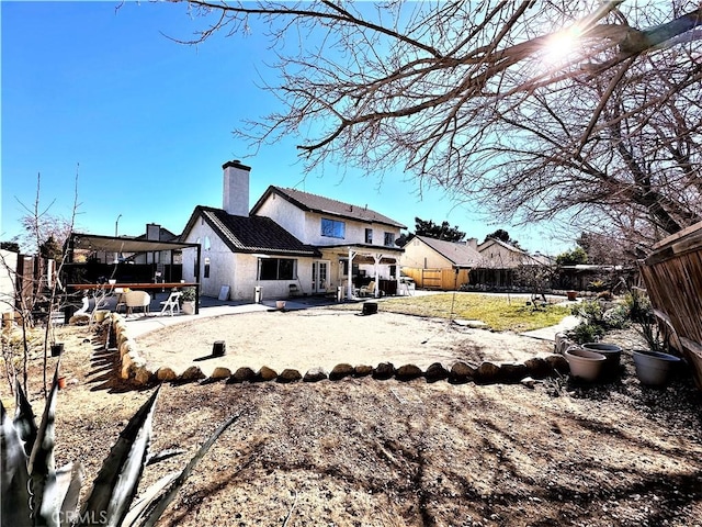 rear view of house featuring a yard and a patio area