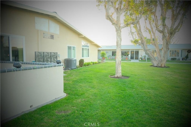 view of yard featuring central AC unit