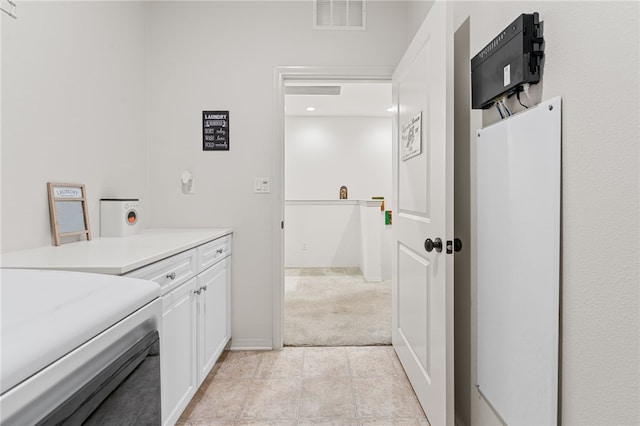 bathroom featuring washer / clothes dryer, visible vents, and baseboards