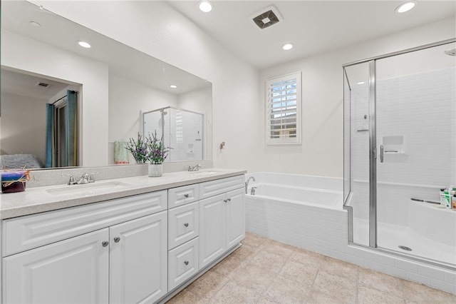 full bathroom featuring a garden tub, double vanity, visible vents, a stall shower, and a sink