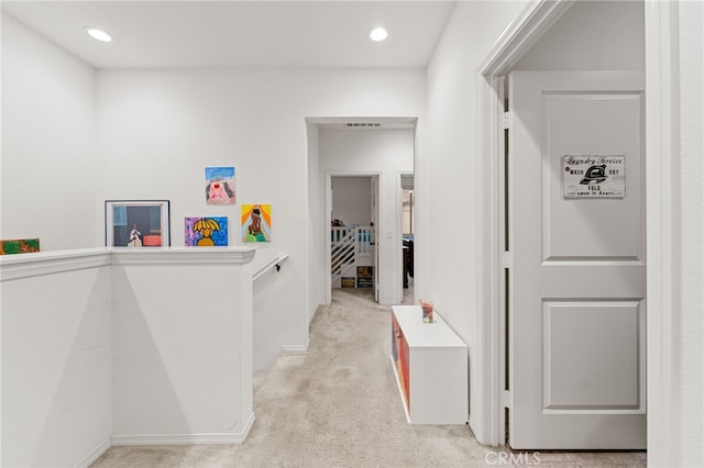 corridor with light colored carpet