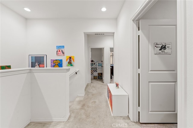 hall featuring recessed lighting, visible vents, and light colored carpet