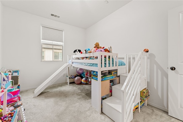 carpeted bedroom featuring visible vents and baseboards