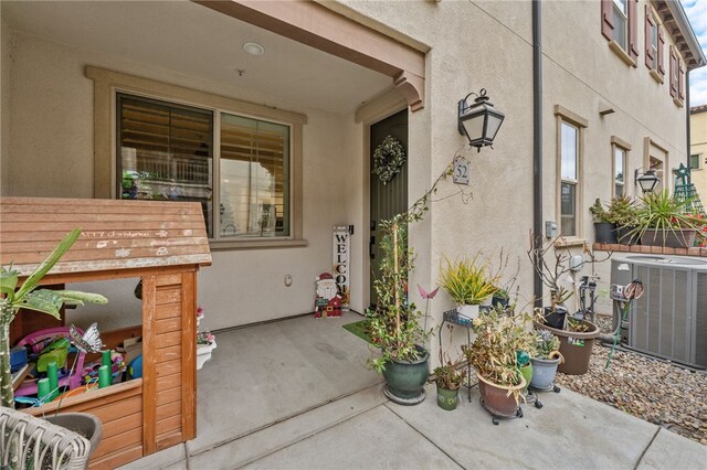 doorway to property with a patio and central AC