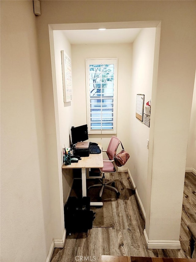 office area with baseboards and wood finished floors