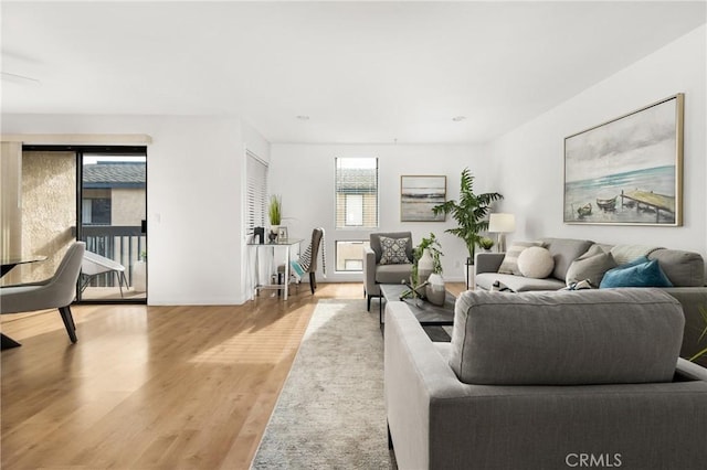 living area with light wood finished floors and baseboards