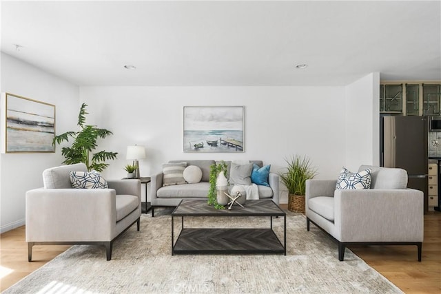 living area featuring wood finished floors and recessed lighting