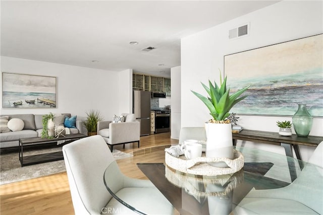 dining room with visible vents and wood finished floors