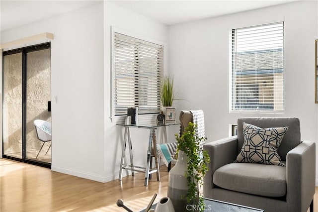 living area featuring wood finished floors and baseboards