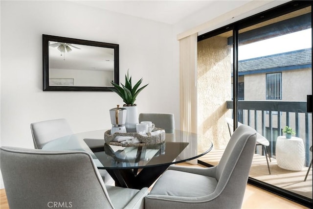 dining space with wood finished floors