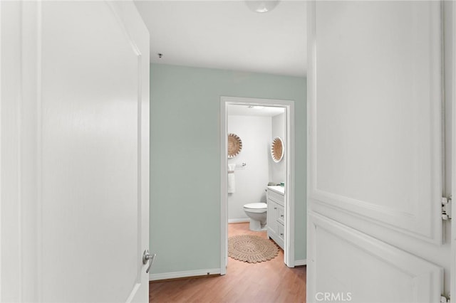 bathroom with hardwood / wood-style floors, toilet, and vanity