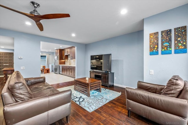 living room featuring ceiling fan, dark hardwood / wood-style flooring, and sink