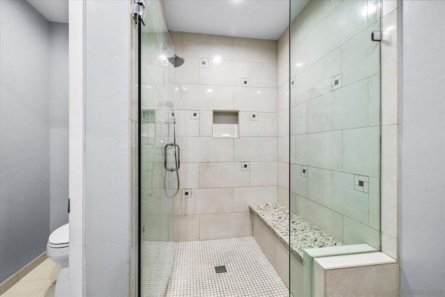 bathroom with toilet, tile patterned flooring, and an enclosed shower