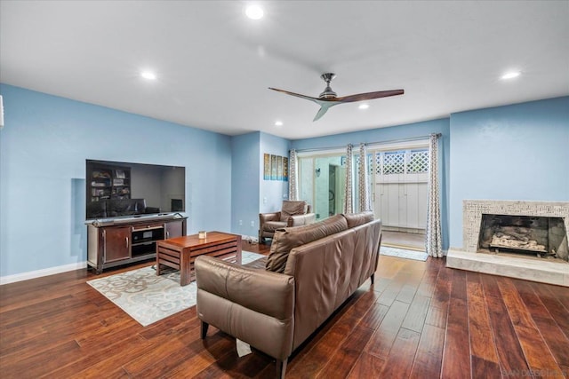 living room with ceiling fan and dark hardwood / wood-style floors