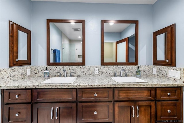 bathroom featuring tasteful backsplash, vanity, and walk in shower