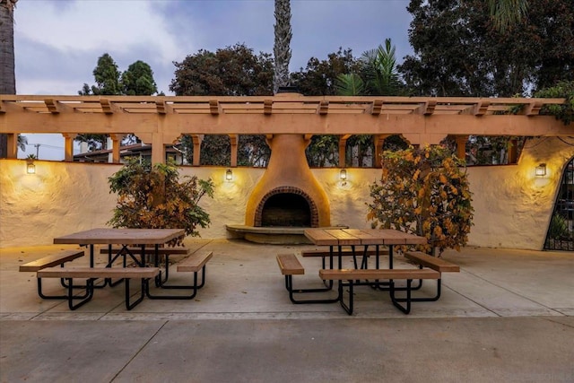 patio terrace at dusk with exterior fireplace