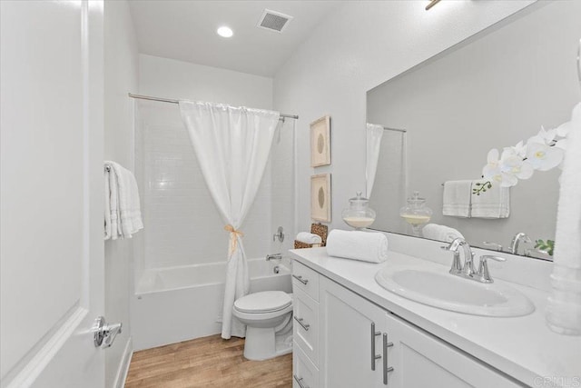 full bathroom featuring shower / tub combo, vanity, hardwood / wood-style flooring, and toilet