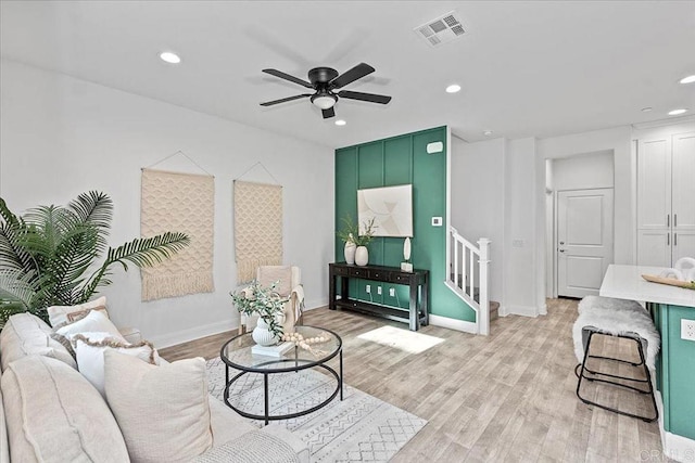 living room featuring light hardwood / wood-style floors and ceiling fan