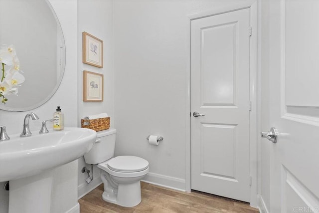 bathroom featuring hardwood / wood-style floors, sink, and toilet