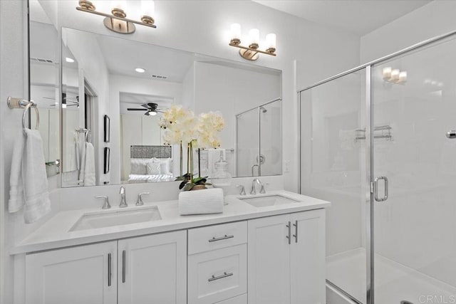 bathroom with vanity, ceiling fan, and a shower with shower door