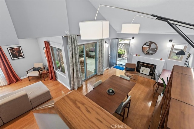 living room featuring light wood-type flooring and a brick fireplace