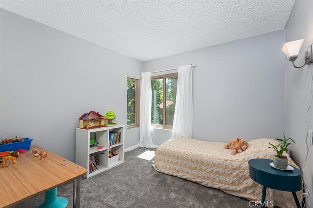 carpeted bedroom featuring a textured ceiling