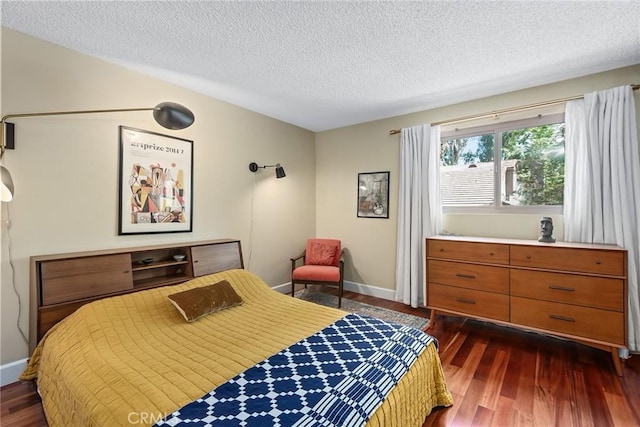 bedroom with dark wood-type flooring and a textured ceiling