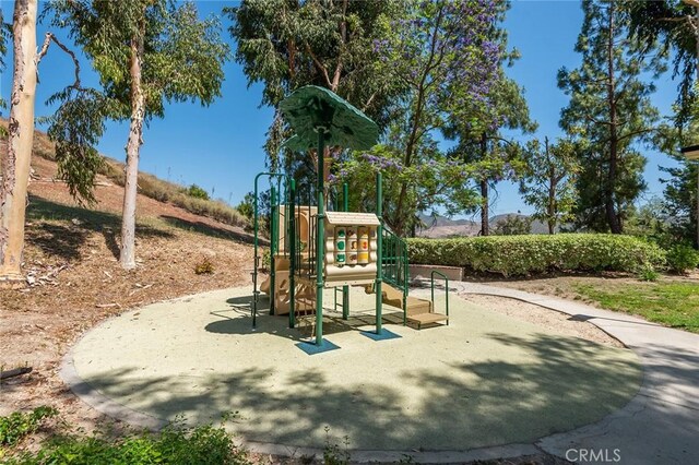 view of playground featuring a mountain view