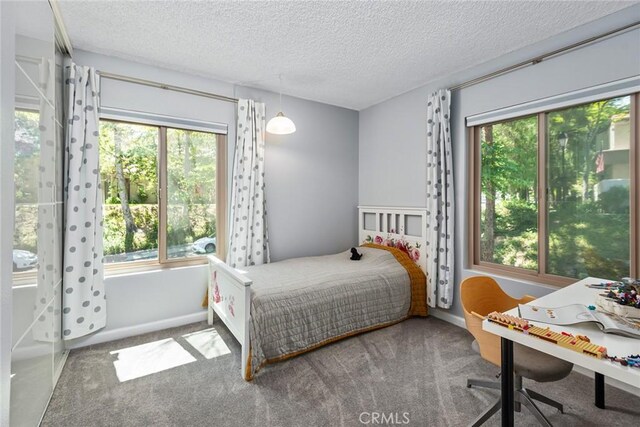 bedroom with a textured ceiling and carpet flooring