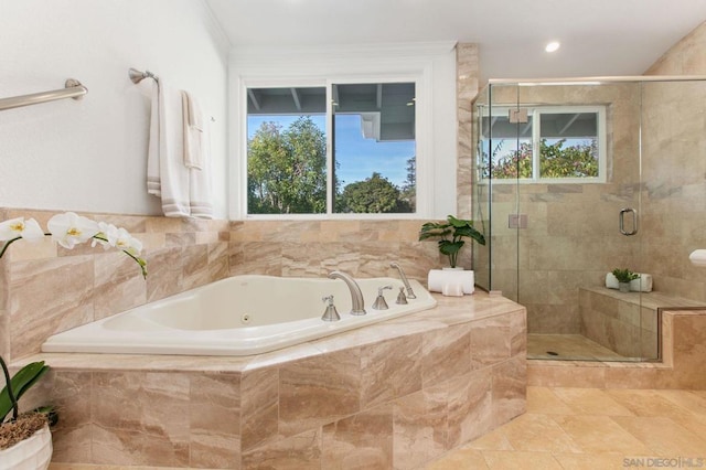 bathroom featuring plenty of natural light and independent shower and bath