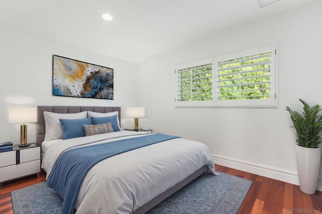 bedroom with dark hardwood / wood-style floors