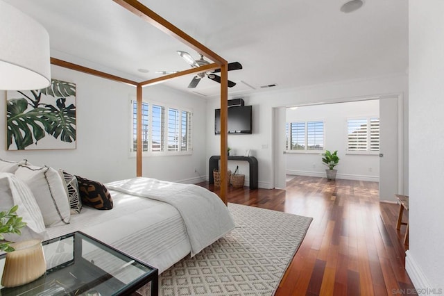 bedroom featuring ceiling fan, dark hardwood / wood-style floors, and crown molding