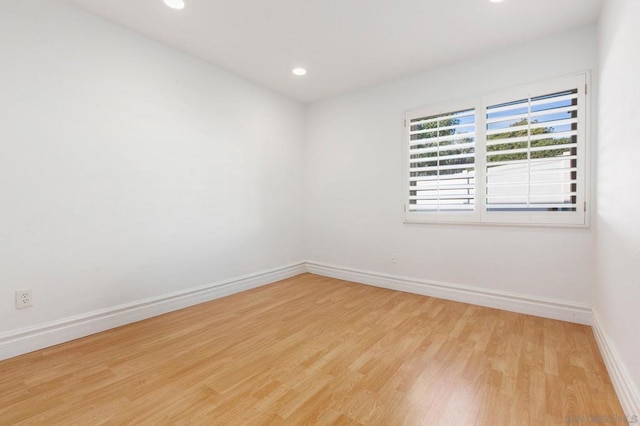 spare room with light hardwood / wood-style flooring