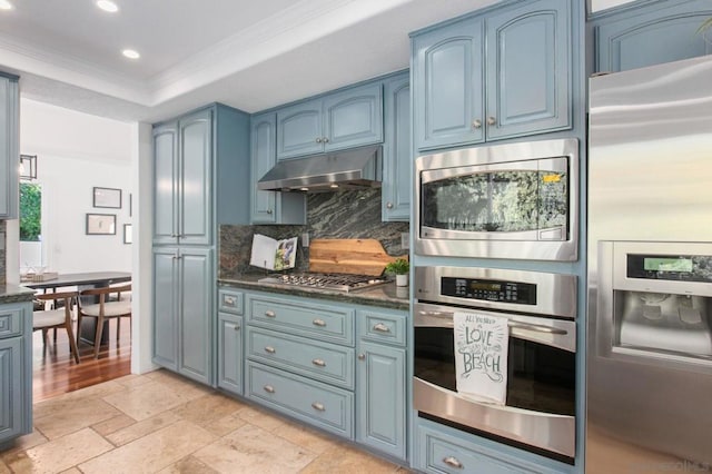 kitchen with stainless steel appliances, blue cabinets, backsplash, and ornamental molding