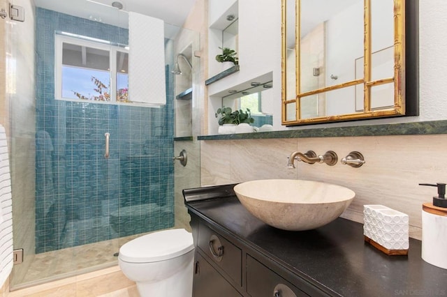 bathroom featuring vanity, backsplash, tile walls, toilet, and walk in shower