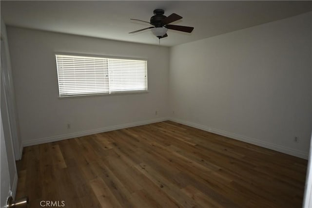 unfurnished room with ceiling fan and dark hardwood / wood-style floors