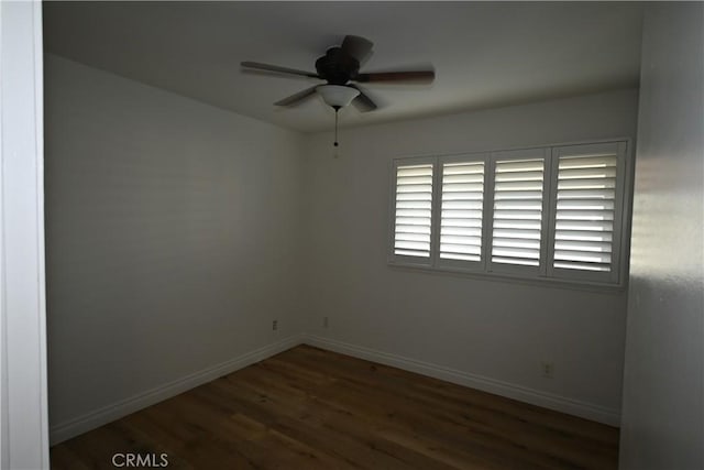 empty room featuring ceiling fan and dark hardwood / wood-style floors