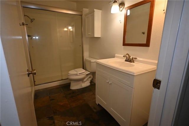 bathroom with vanity, toilet, and walk in shower