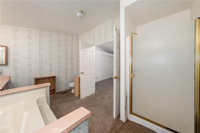 bathroom with toilet and walk in shower