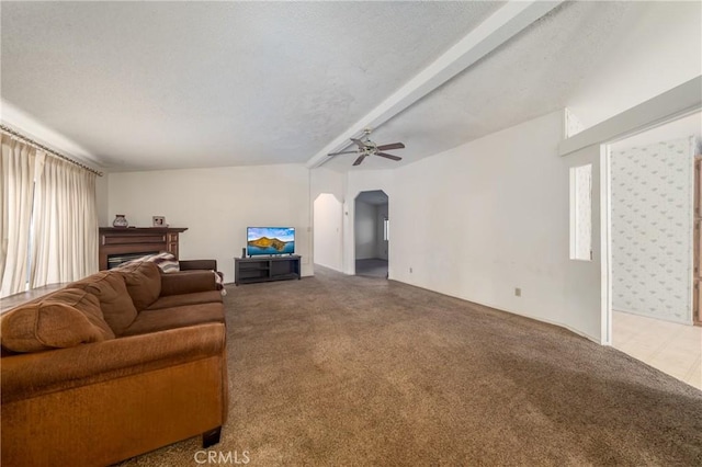 carpeted living room with beam ceiling and ceiling fan