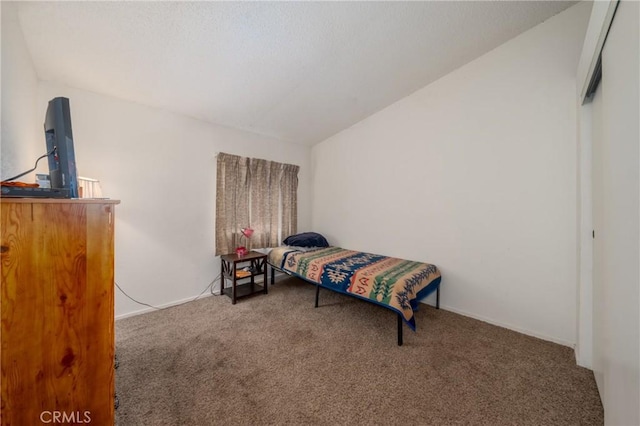 bedroom featuring vaulted ceiling and carpet flooring