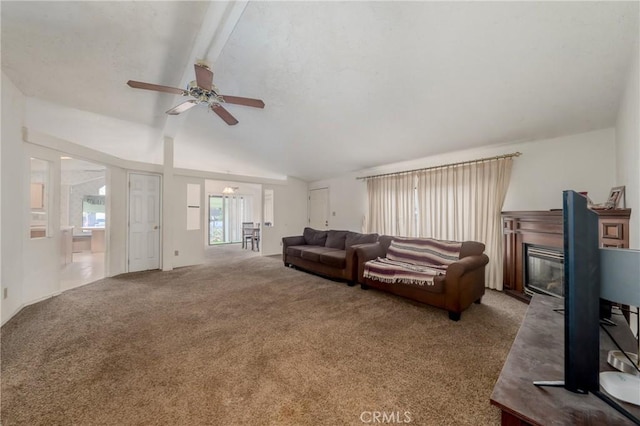 carpeted living room featuring ceiling fan and vaulted ceiling