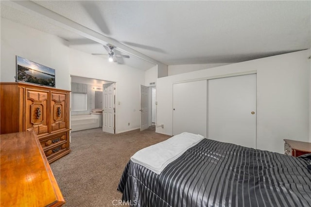 bedroom with ensuite bath, a closet, lofted ceiling with beams, carpet flooring, and ceiling fan