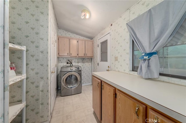 clothes washing area with washer / clothes dryer and cabinets