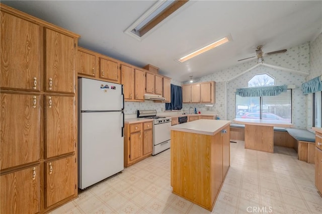 kitchen with ceiling fan, a center island, white appliances, vaulted ceiling, and sink